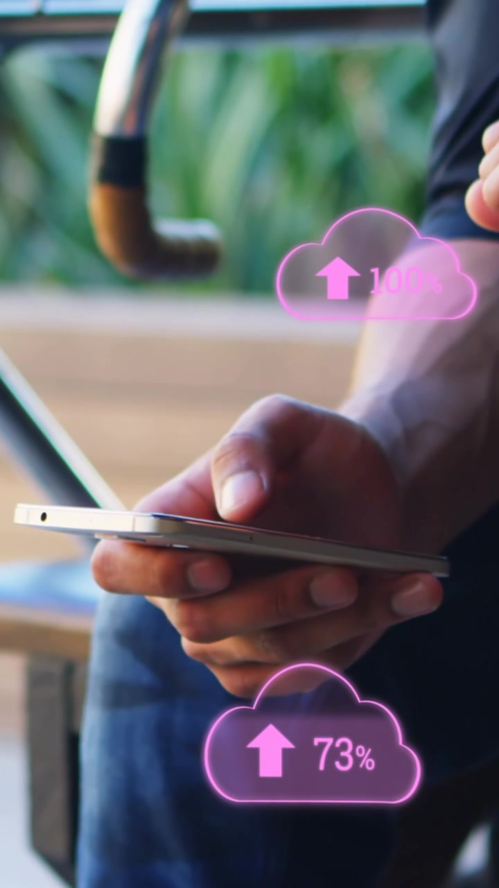 Animation of clouds with arrows and percent going up over caucasian man using smartphone
