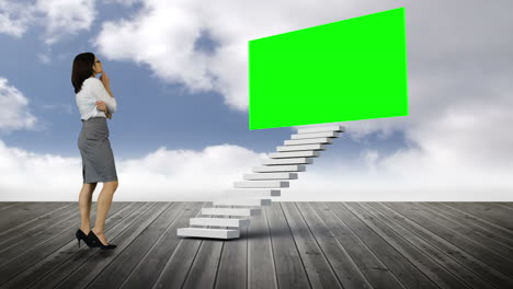 businesswoman looking at stair with a green screen on wood ground