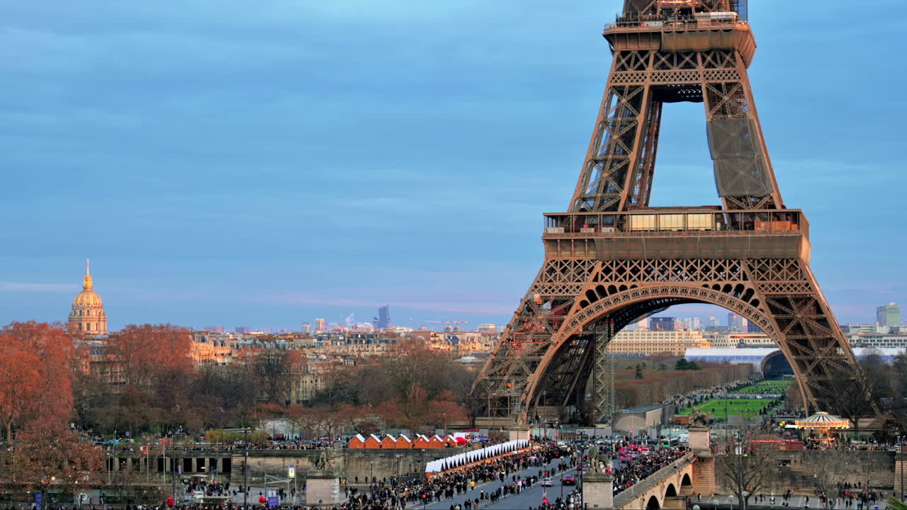 View of the Eiffel Tower in Paris from the Trocadero Square at sunset, France. Jena Bridge with multiple people and cars, cityscape