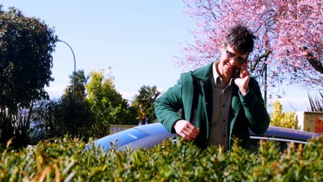 man talking on mobile phone in the park 4k