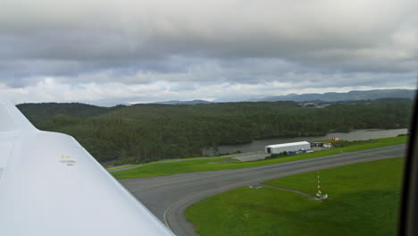 looking out of an aeroplane window on approach to landing on a runway