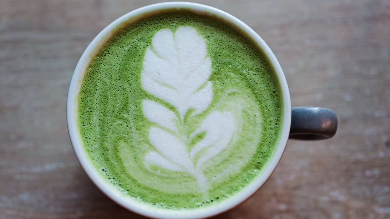 Close up of a matcha latte on a wooden table