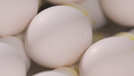 close-up of fresh eggs moving along a conveyer at a poultry farm