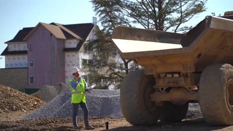 Woman-engineer-project-manager-uses-a-smartphone-on-a-construction-site-to-talk-to-colleagues