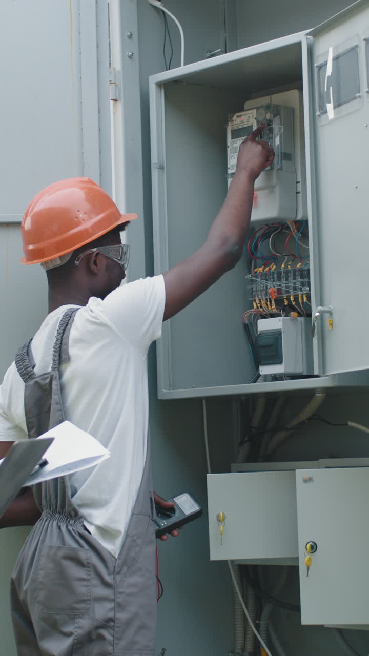 Electrician inspecting electrical panel