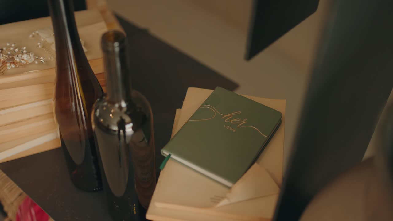 Quaderno con promesse di matrimonio appoggiato su un tavolo di legno con bottiglie di vetro