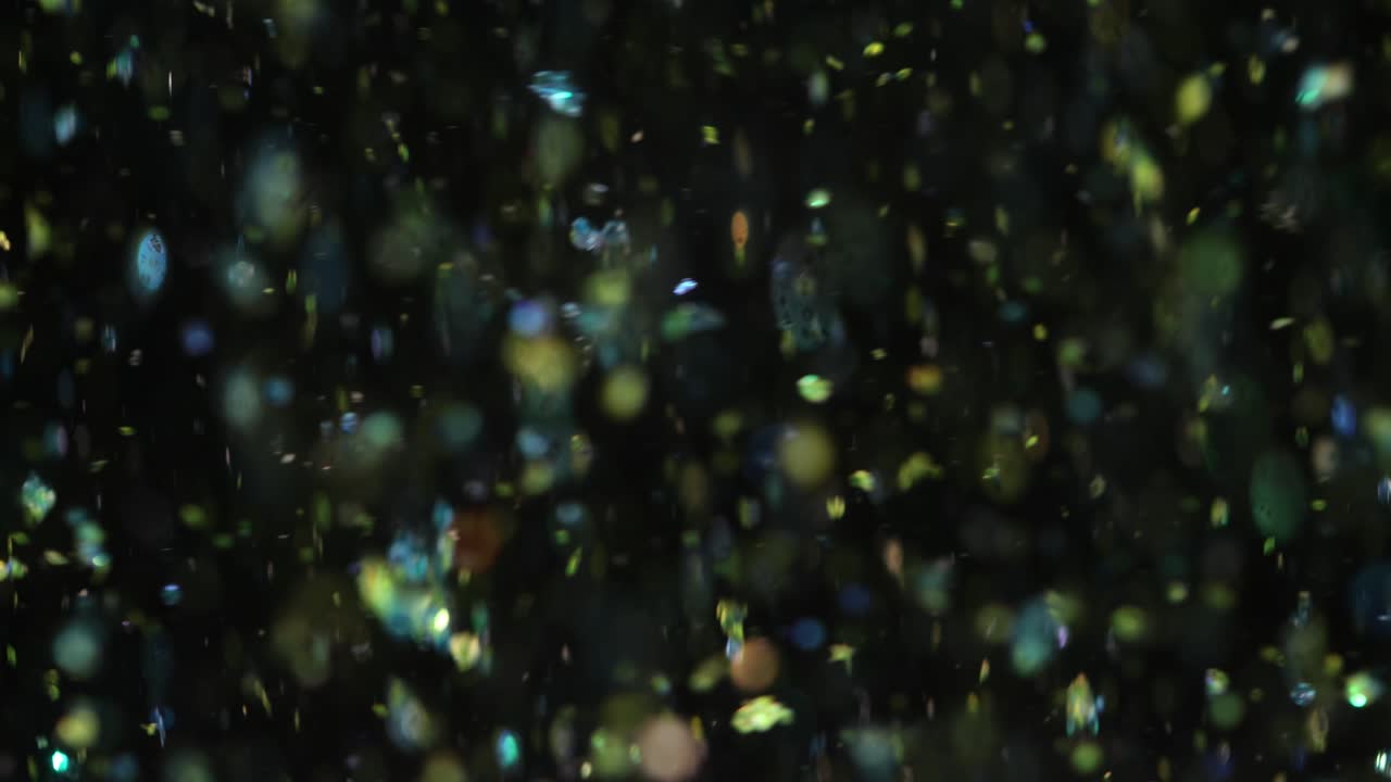 Abstract Glittering Particles on a Dark Background