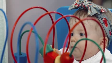 child plays with a multi-colored toy 11