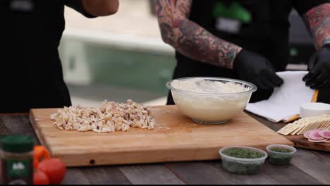 a man folds a towel as he prepares to cook on the