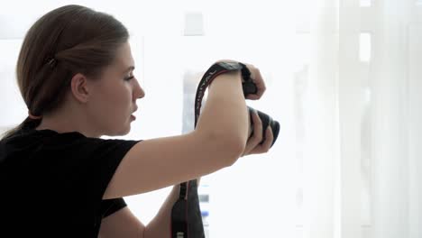 woman taking a photo by the window