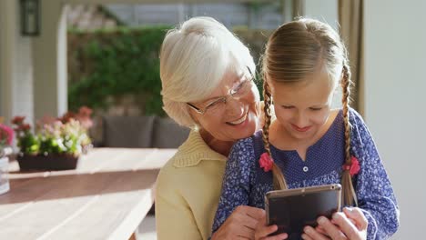 Grandmother-and-little-girl-using-tablet-4K-4k