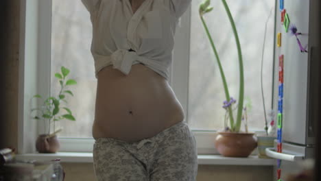 happy and active pregnant woman dancing at home