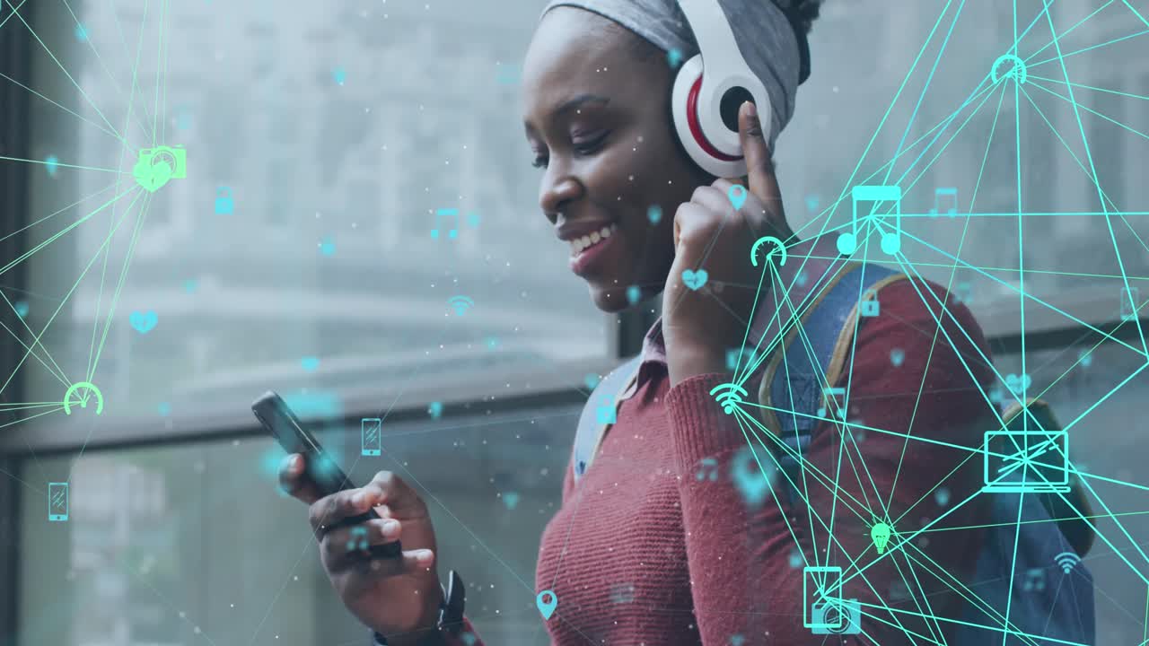 Animation of connected media icons over happy african american woman using smartphone and headphones