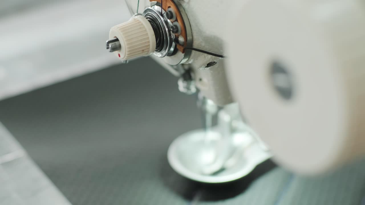 Closeup of sewing machine working part with leather. Cnc sewing machine