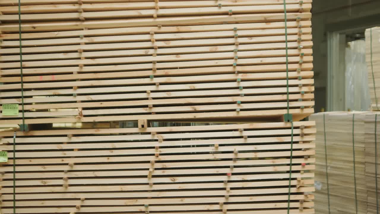 Forklift Moving Stacked Lumber in a Warehouse