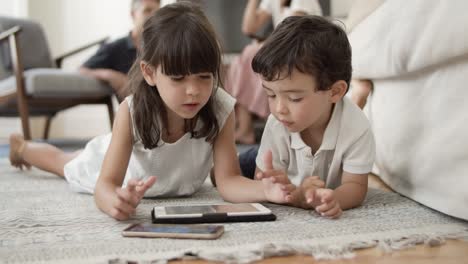 Adorable-little-kids-lying-on-floor-in-living-room