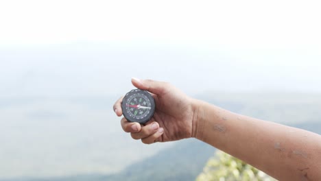 hand holding a compass for travel.