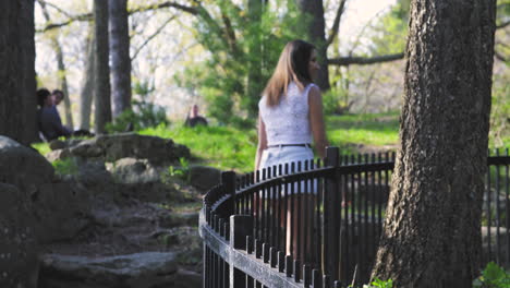 attractive, young woman walking in a park