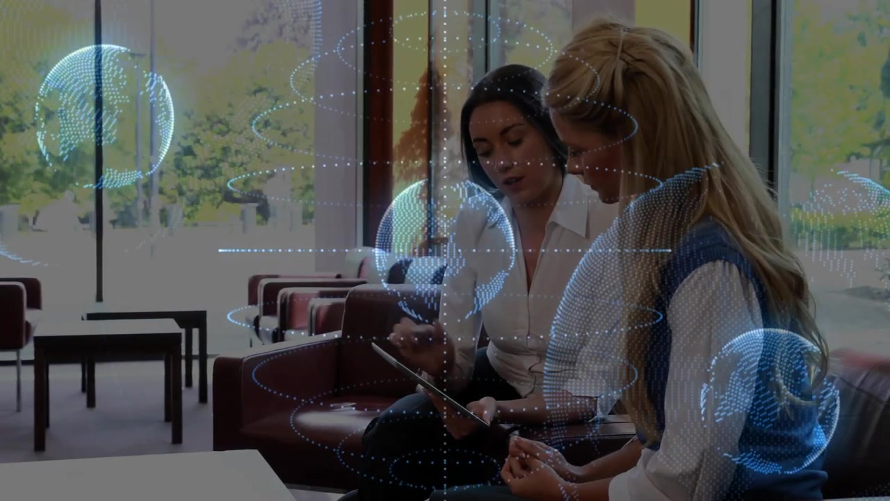 Business presenter tapping tablet showing rotating globes and business charts for collaboration