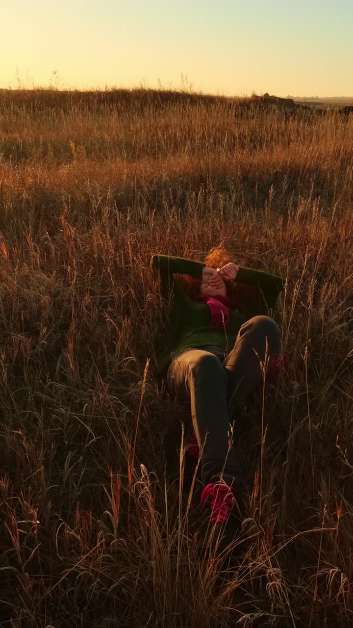 Woman enjoying the sunset in a field