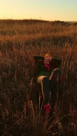 woman enjoying the sunset in a field