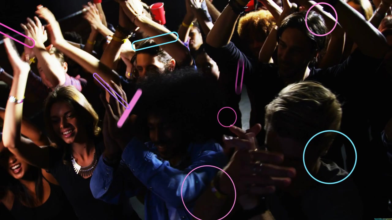 Front-row crowd clapping and swaying to music, beat releasing neon shapes growing over faces