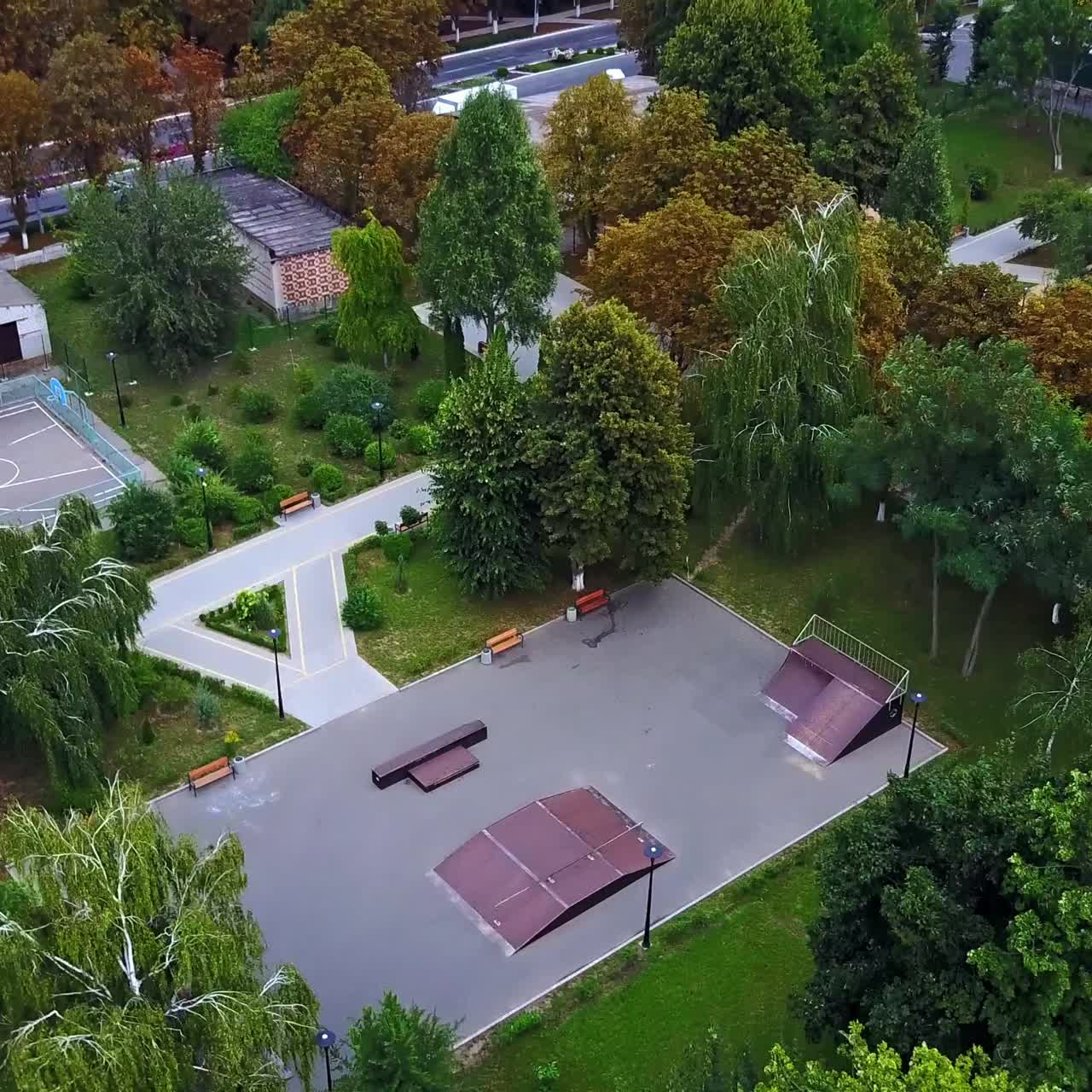 Artificial oval pond with group of fountains in the middle. Beautiful park in the city. Top view