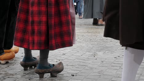 static shot of clogs and red black skirt, traditional clothes, madrid to trashumancia festival, copy space