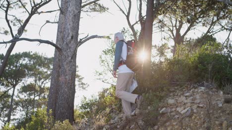 Senior-man-hiking-in-the-forest-on-a-sunny-day-4k