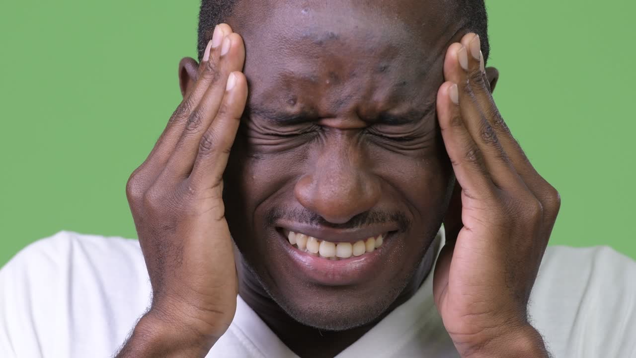 Young African man having headache