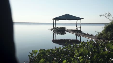 gazebo on river reveling sunlight reflecting in water