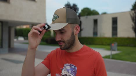 vlogger attaching action camera to brim of baseball cap