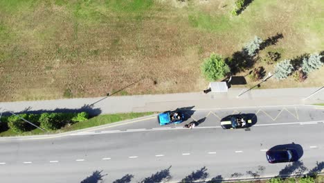 aerial view of cars on a city street and park