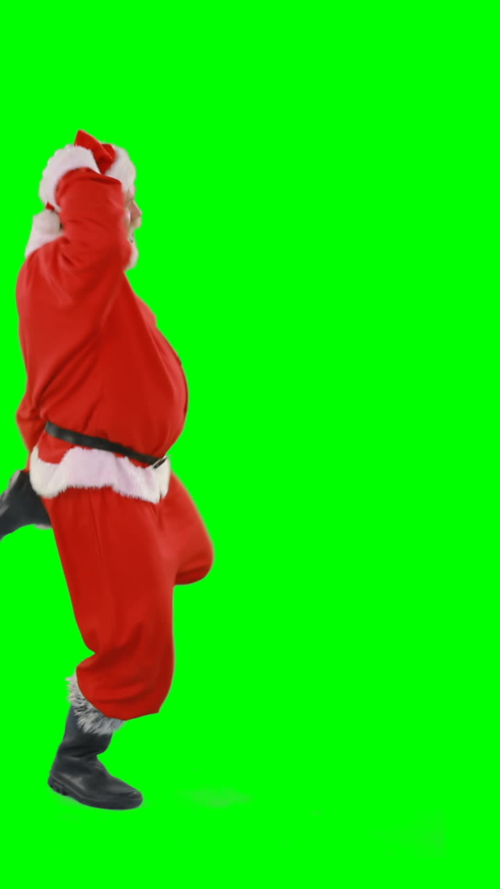 santa claus bailando contra un fondo verde