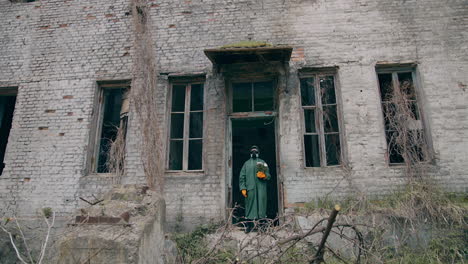 man in biohazard suit with plant. person in protective suit standing in ruined city.