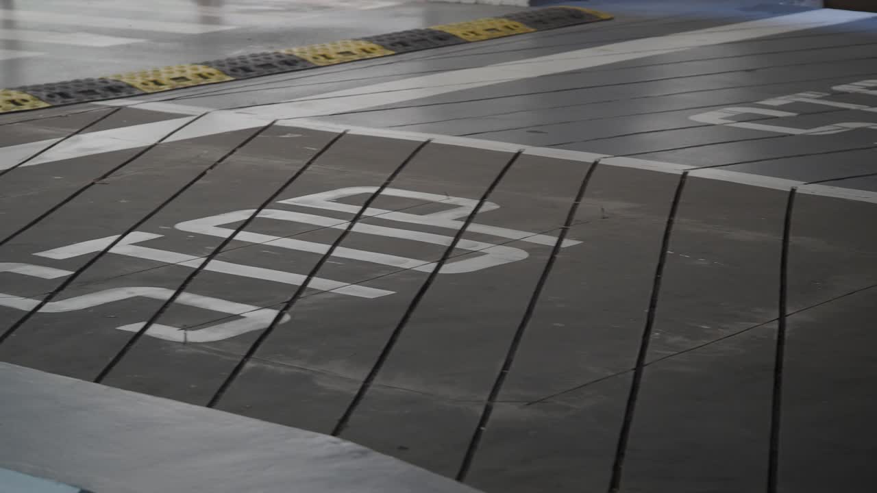 STOP sign and speed bump on a sloped road surface