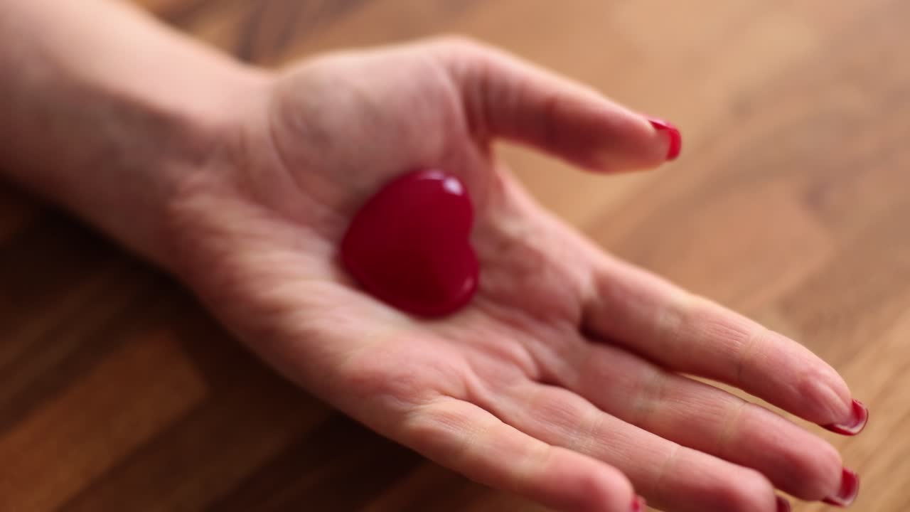 A red heart in a hand