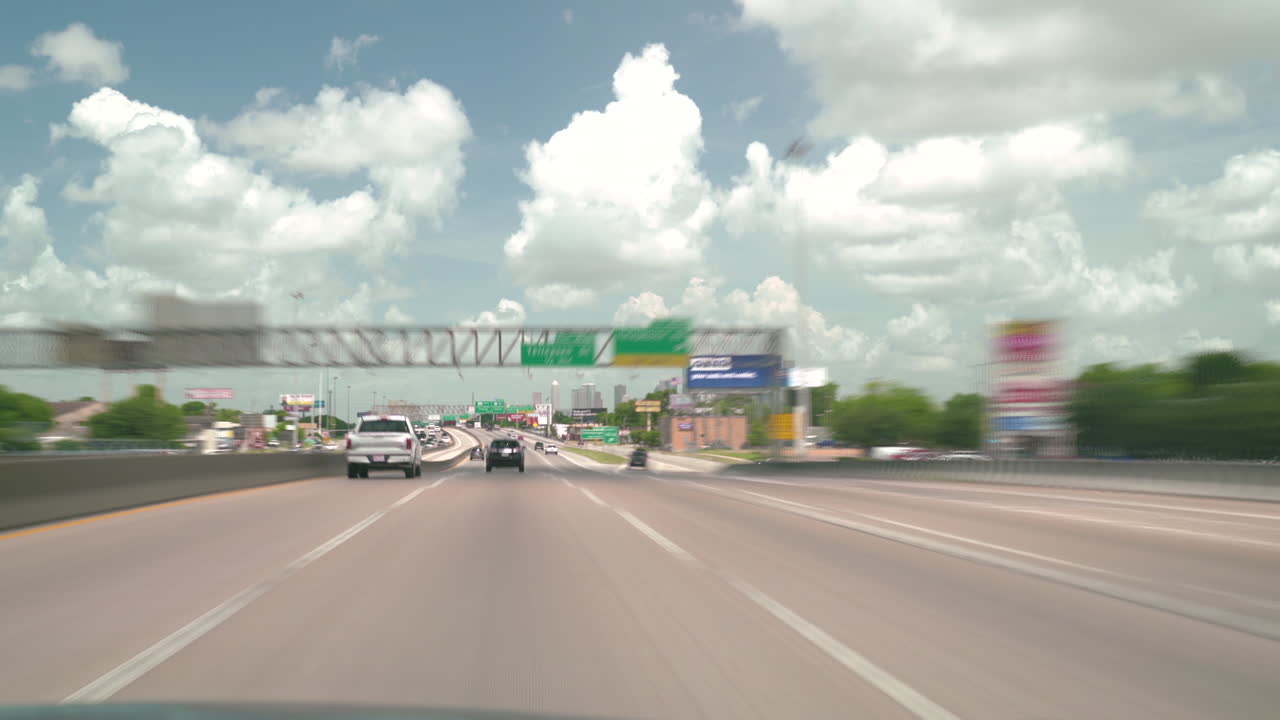 Time-lapse traffic on Houston Freeway I45 northbound to downtown. Texas transportation timelapse on interstate highway 45 to downtown Houston. Car driving on highway fast forward on cloudy day