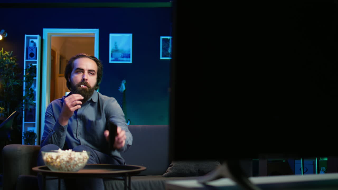 persona que viene a casa a ver películas transmitidas en la televisión y comer palomitas de maíz