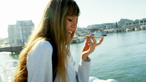 Woman-talking-on-mobile-phone-while-travelling-in-ferry-4k