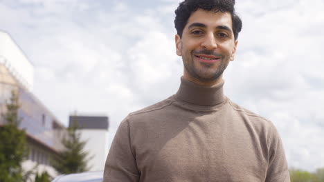 young man looking at camera outdoors