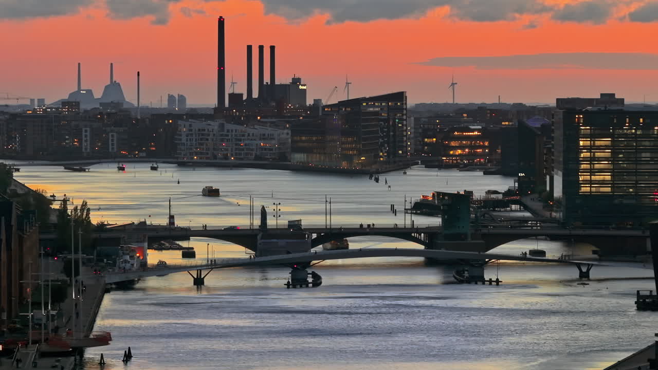 Aerial drone view of people moving on the Quay Bridge across the port of Copenhagen, Denmark in the evening