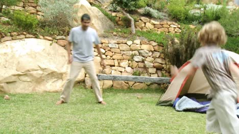 father and son playing football