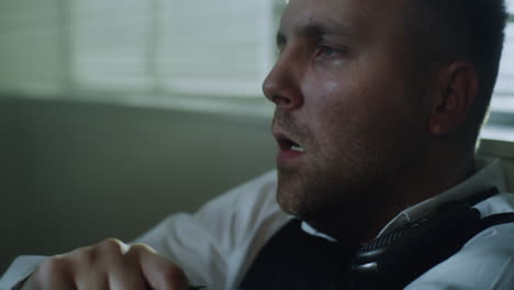 close-up of a man with an intense and sweaty expression