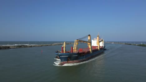 cargo ship sailing into harbor, ocean background