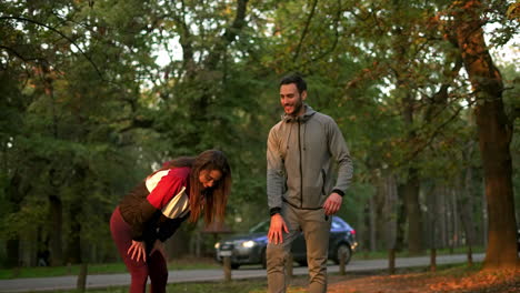 couple exercising in the woods