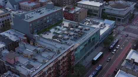 aerial footage spins around looking at rooftops of the harlem neighborhood in new york city in the early morning