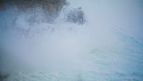 violent ocean waves crashing wild cliff closeup. seashore storm crashing rocks