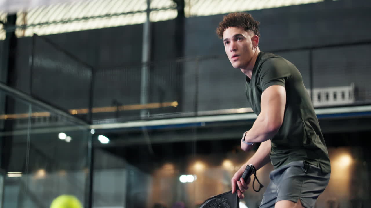 A man playing padel indoor