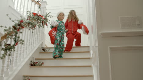 Slow-Motion-Shot-Of-Children-On-Stairs-With-Christmas-Gifts